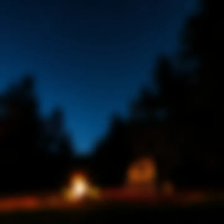 Nighttime view of a campground with starlit sky and glowing campfire ambiance
